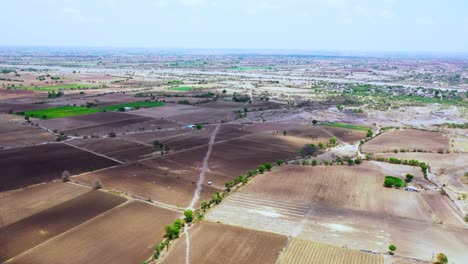 Aerial-camera-moving-fast-forward-above-Indian-farming-land-and-agricultural-land