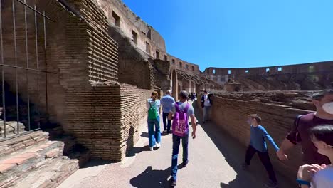 POV-walking-around-the-Roman-Colosseum-in-Rome,-Italy