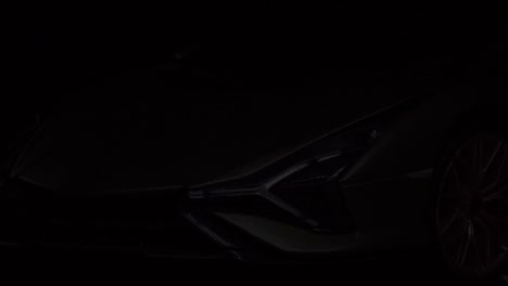 Close-up-silhouette-shot-of-a-new-aggressive-sports-car-being-revealed-for-the-upcoming-launch