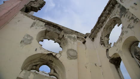 Detail-of-Cathedral-of-Port-Au-Prince-in-ruins,-low-angle-pan-right