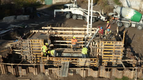 Construction-workers-working-on-formwork-made-of-wood-and-steel