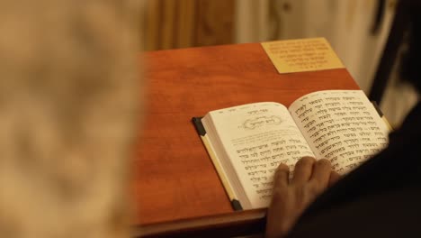 Close-up-shot-of-Orthodox-Religious-Jew-reading-The-Psalms---Chapter-at-Walls-of-Jerusalem