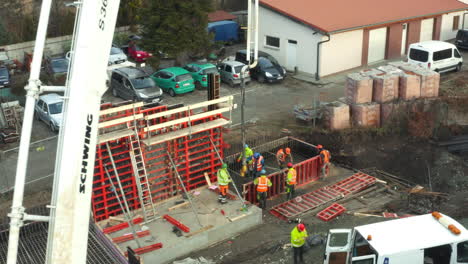 Construction-workers-pumping-concrete-into-building-foundations