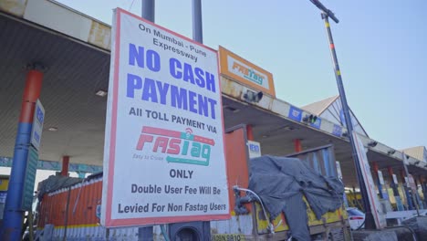 Vehicles-in-front-of-a-toll-booth-showing-the-new-RFID-based-payment-system-FASTag-along-with-the-logo-for-the-national-highway-authority-of-India-NHAI-on-Mumbai-Pune-Expressway