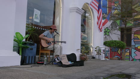 Melodic-guitar-playing-by-street-artist-in-hat-near-Malacca-River