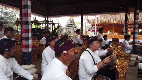 Musicians-Playing-Gamelan-Music-in-Bali-Indonesia,-Temple-Ceremony-wearing-Traditional-Clothes,-Cultural-Travel-and-Tourism-Southeast-Asia