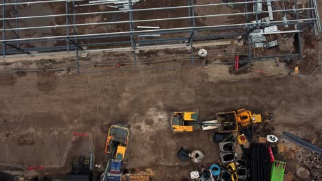 ALDI-supermarket-construction-building-site-aerial-view-zoom-in-towards-bulldozer