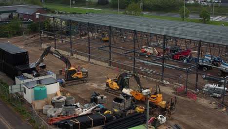 ALDI-supermarket-construction-building-site-aerial-view-rising-over-industrial-framework-development,-UK