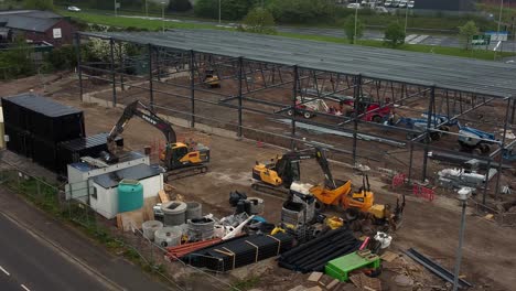 ALDI-supermarket-construction-building-site-aerial-view-orbiting-industrial-framework-development,-UK