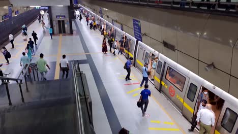 passenger-boarding-and-deboarding-from-metro-train-at-station-at-morning-from-top-angle-video-is-taken-at-hauz-khas-metro-station-new-delhi-india-on-Apr-10-2022