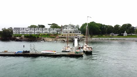 Pier-with-moored-boats-and-a-Victorian-house-with-American-flags