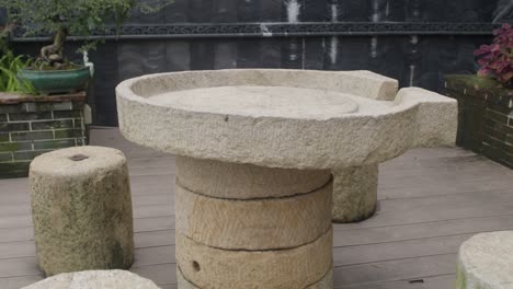 Stylized-stone-table-and-stone-seats-in-an-Asian-style-garden