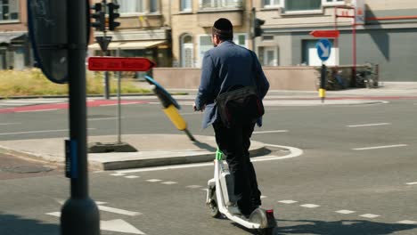 Jewish-man-with-Kippah-hat-on-electric-scooter-in-the-Antwerp-diamond-district-Belgium