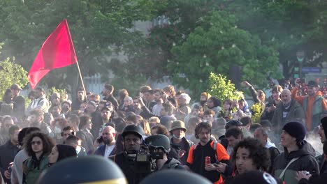 Left-wing-protests-wave-red-flags-during-the-May-Day-protests-in-Paris,-France