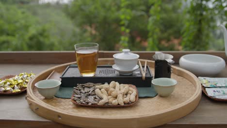 A-set-for-Chinese-tea-ceremony-on-a-wooden-table-on-outdoor-terrace