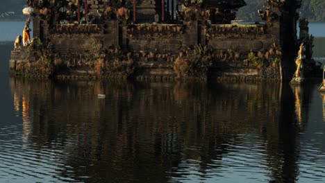 Ascending-slow-motion-shot-of-beautiful-water-temple-on-bali-panoramic-shot-of-Pura-Segara-Ulun-Danu-Batur-temple-on-volcanic-lake-Batur-on-Bali-in-Indonesia