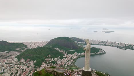 Flyover-Christ-the-Redeemer-Statue-on-Top-of-Corvocado-Hill,-revealing-Rio-de-Janeiro-Landscape
