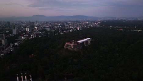 Aerial-view-around-the-Chapultepec-castle,-dusk-in-Mexico-city---orbit,-drone-shot