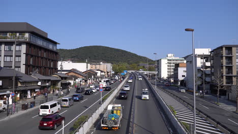 KYOTO,-JAPAN---April-3,-2023:-View-of-Gojo-dori-street-traffic-from-footbridge