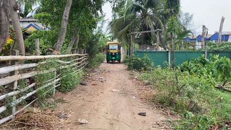 An-auto-coming-towards-the-camera-in-an-Indian-village-road