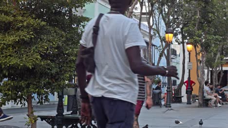 People-walk-by-in-Plaza-de-Armas-in-Viejo-San-Juan-historical-town-of-San-Juan,-Puerto-Rico