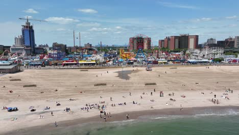A-slow-panning-shot-of-Brighton-beach-and-the-Coney-Island-Boardwalk-with-the-skyline-of-New-York-City-in-the-background