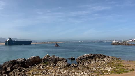 Wide-shot-showing-large-UECC-Cargo-Ship-on-Bay-of-Santander-arriving-port-in-Spain-during-sunny-day