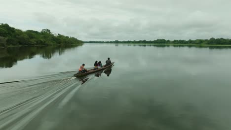Aerial-follows-a-Canoe-crossing-the-amazonas-River-in-Peru-during-daytime