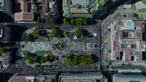 Aerial-high-angle-shot-of-May-Square-and-Casa-Rosada-crowded-with-a-multitude-of-people,-city-jam-in-Buenos-Aires,-Argentina