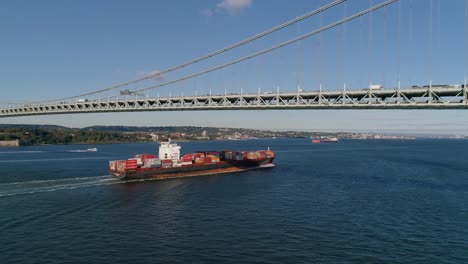 Aerial-Dolly-Shot-of-Freighter-Passing-under-Verrazzano-Bridge-in-New-York-City