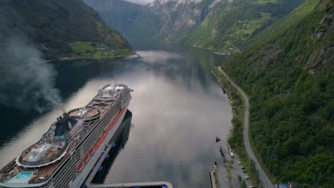Aerial-Shot-of-Cruise-Ship-Setting-Sail-Thru-Geirangerfjord-in-Norway