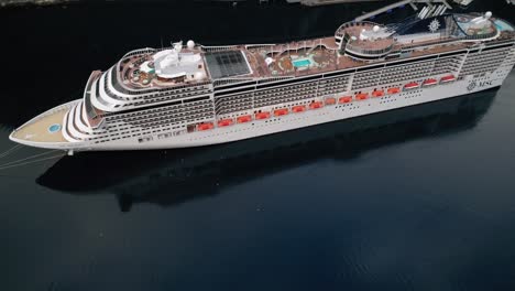 Orbit-Shot-of-the-MSC-Preziosa-Cruise-Ship-Docked-in-the-Geirangerfjord-in-Norway