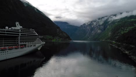 Front-Forward-Dolly-Shot-of-the-MSC-Preziosa-Cruise-Ship-Docked-in-the-Geirangerfjord-in-Norway
