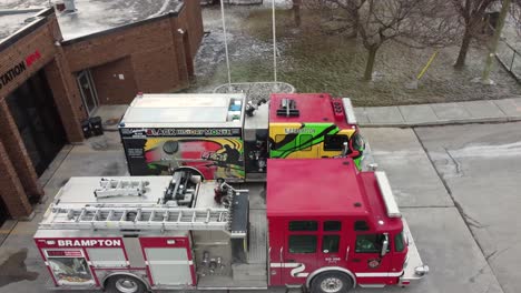 aerial-push-in-shot-to-brampton's-fire-department-colorful-truck-parked-outside-the-station