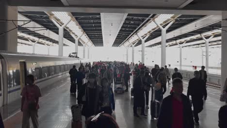 Silhouette-of-passengers-crowd-moving-off-the-train-and-walk-on-platform-in-a-railway-station-in-China