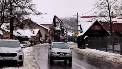 Wet-Asphalt-Road-On-The-Winterly-Village-Of-Bran-In-Brașov-County,-Transylvania,-Romania