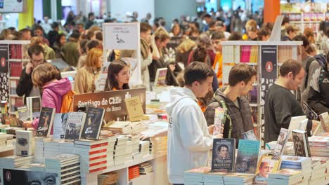 Static-medium-view-of-young-adults-walking-through-and-looking-at-new-books-and-literature