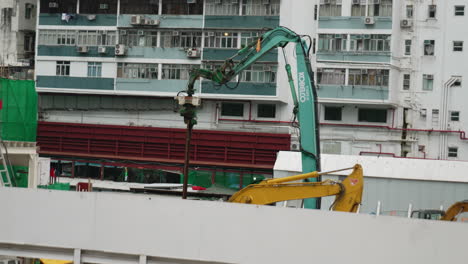 Excavator-and-heavy-machinery-drill-work-on-construction-site-in-hong-kong-city