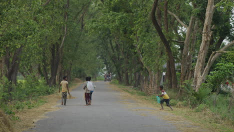 Bangladeshi-poor-village-boys-walking-on-the-street-village-roadside-view,-Rural-Bangladesh