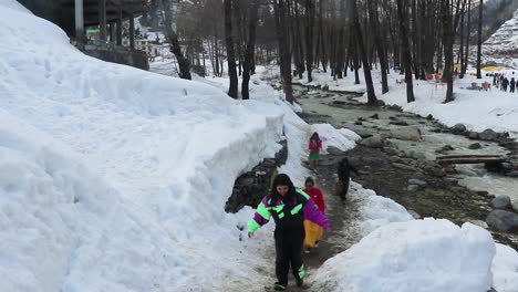 tourists-walking-on-snow-at-day-from-flat-angle-video-is-taken-at-manali-himachal-pradesh-india-on-Mar-22-2023