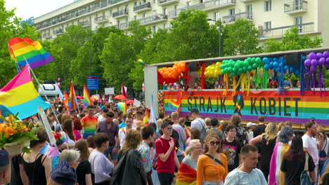 Colorfully-dressed-people-during-an-equality-march---LGBT-flags,-clothes-in-colors-of-freedom,-float-with-people
