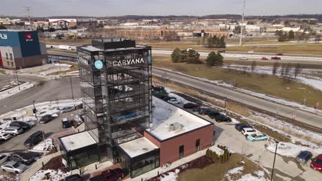 Carvana-glass-building-for-cars-advertising,-aerial-drone-view