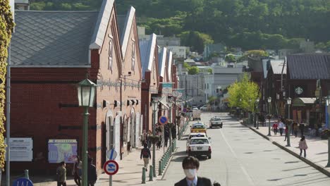 People-Walking-Along-Famous-Kanemori-Red-Brick-Warehouses-In-Hakodate-On-Sunny-Day