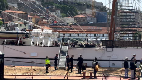 Slow-motion-wide-shot-of-captains-of-NRP-Sagres-Sail-Training-Vessel-leaving-ship-at-Port-of-Oporto-in-May-2023