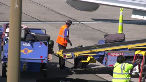 Baggage-Handlers-take-baggage-from-aircraft