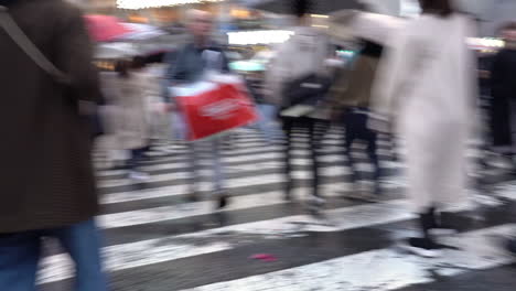 TOKYO,-JAPAN---APRIL-8,-2023:-View-of-Shibuya-Crossing,-one-of-the-busiest-crosswalks-in-the-world-in-a-raining-day