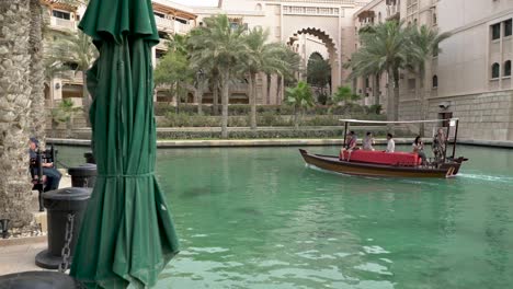Abra-Boat-Ride-Through-The-Canal-In-Madinat-Jumeirah,-Dubai,-United-Arab-Emirates
