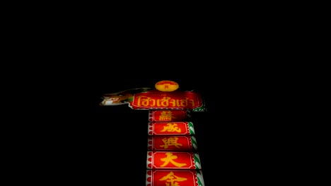 A-Huge-Chinese-Signage-Against-The-Dark-Sky-In-Chinatown,-Bangkok,-Thailand-Illuminated-In-The-Evening---tilt-up-shot