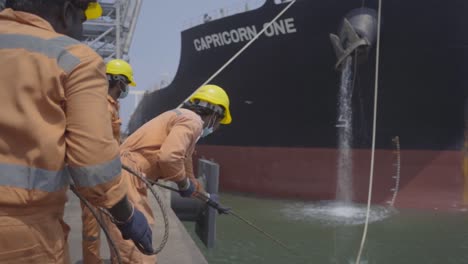 Dockers-Pulling-Mooring-Line-Of-A-Huge-Vessel-Anchoring-At-The-Port-Of-Paradip-In-India