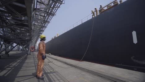 Stevedores-Working-At-The-Port-Of-Paradip-In-India,-Docking-Big-Container-Vessel-At-Daytime